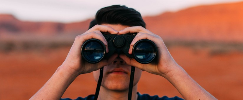 person looking through binoculars